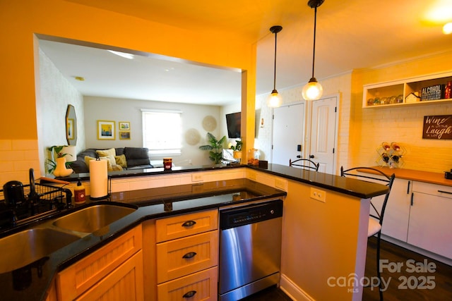 kitchen with sink, decorative light fixtures, stainless steel dishwasher, kitchen peninsula, and backsplash