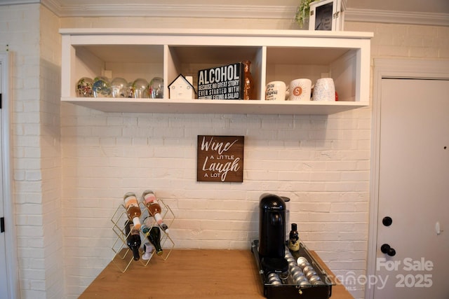 mudroom with brick wall and ornamental molding