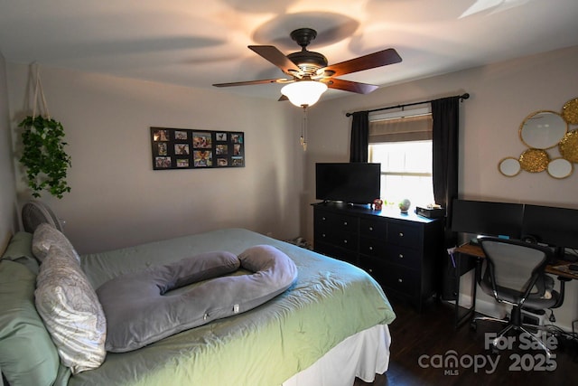 bedroom with dark hardwood / wood-style floors and ceiling fan