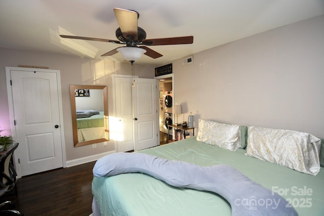 bedroom with dark hardwood / wood-style flooring and ceiling fan