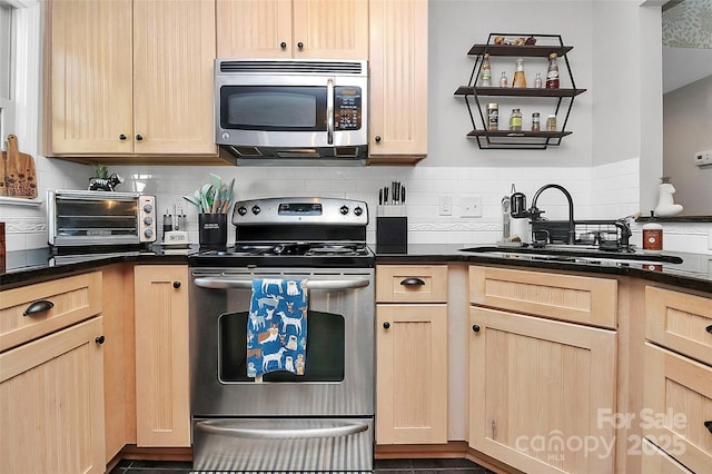 kitchen with stainless steel appliances, sink, and light brown cabinets