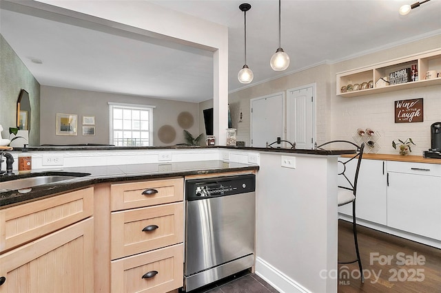 kitchen featuring dishwasher, backsplash, hanging light fixtures, kitchen peninsula, and light brown cabinets