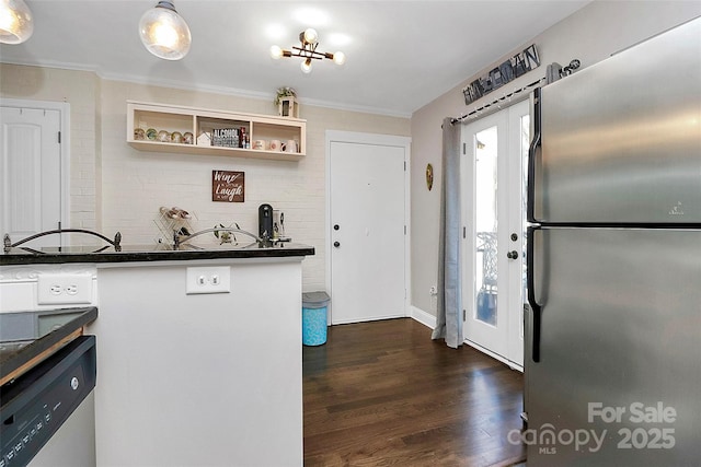 kitchen with crown molding, appliances with stainless steel finishes, and dark wood-type flooring