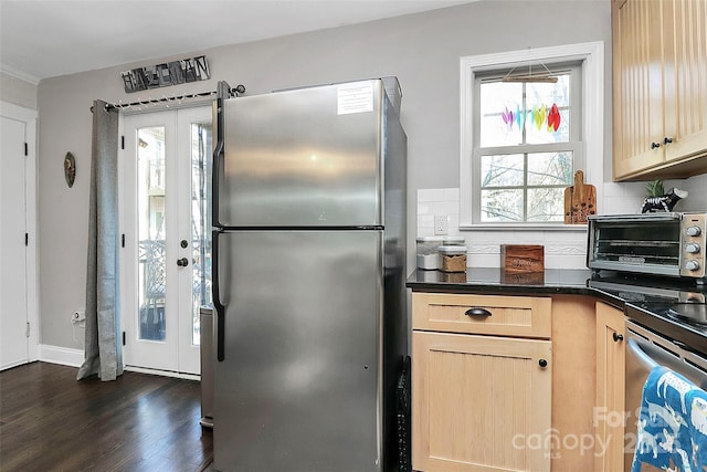 kitchen featuring appliances with stainless steel finishes, backsplash, dark hardwood / wood-style floors, light brown cabinetry, and french doors