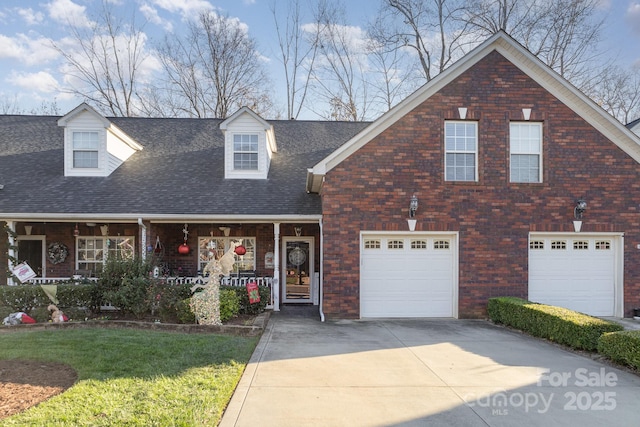 view of front of home featuring a garage, a front yard, and a porch