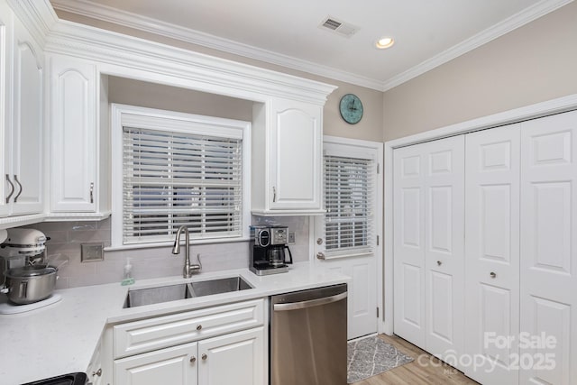 kitchen featuring sink, dishwasher, tasteful backsplash, ornamental molding, and white cabinets