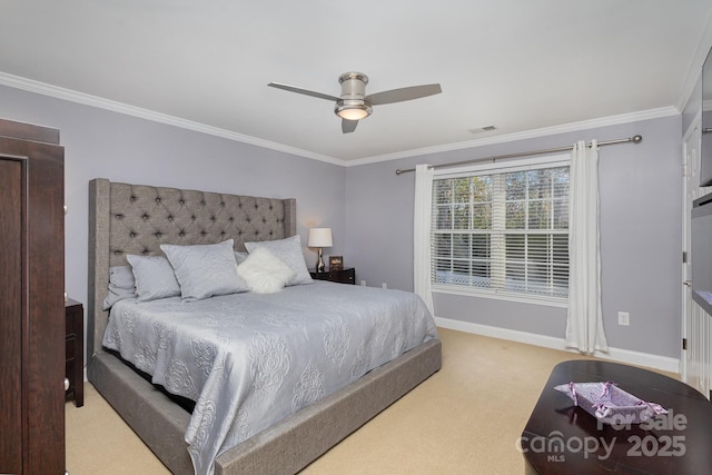 bedroom featuring light carpet, ornamental molding, and ceiling fan