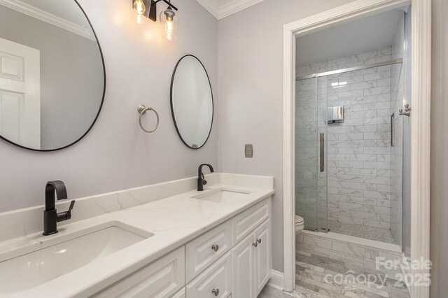 bathroom with vanity, ornamental molding, toilet, and walk in shower