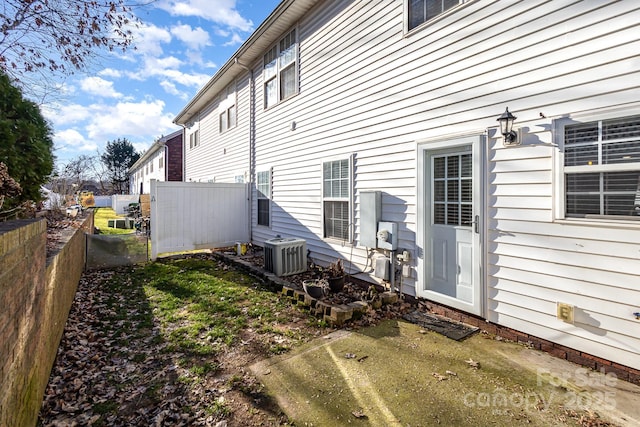 rear view of house featuring central air condition unit