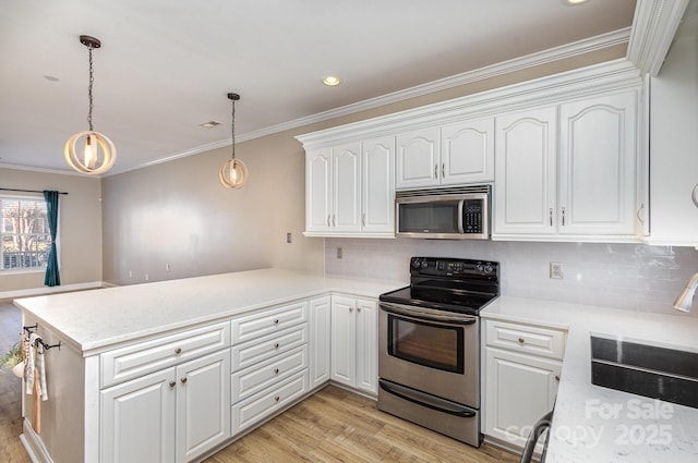 kitchen featuring white cabinetry, kitchen peninsula, pendant lighting, stainless steel appliances, and light hardwood / wood-style floors