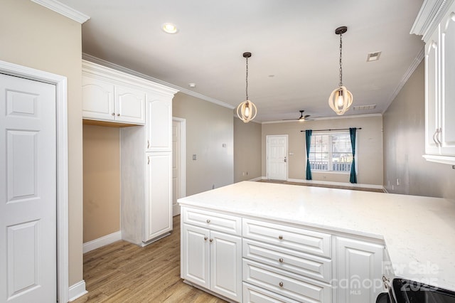 kitchen with white cabinetry, light hardwood / wood-style flooring, ornamental molding, kitchen peninsula, and pendant lighting