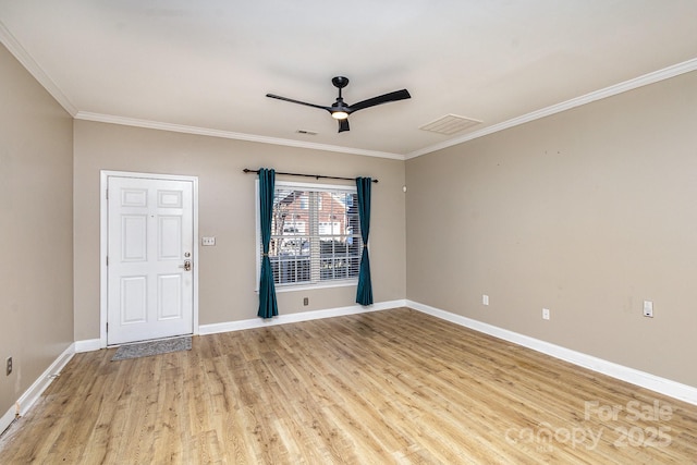 empty room with ceiling fan, ornamental molding, and light wood-type flooring