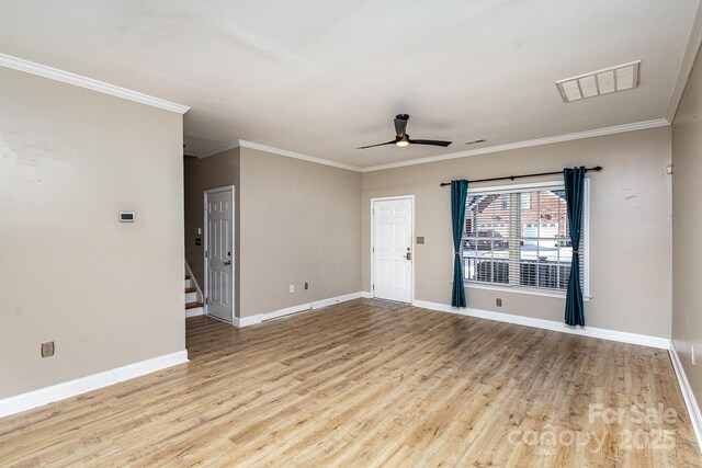 empty room featuring ornamental molding, ceiling fan, and light wood-type flooring