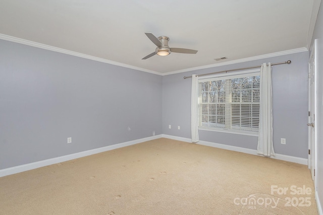 empty room with crown molding, carpet floors, and ceiling fan