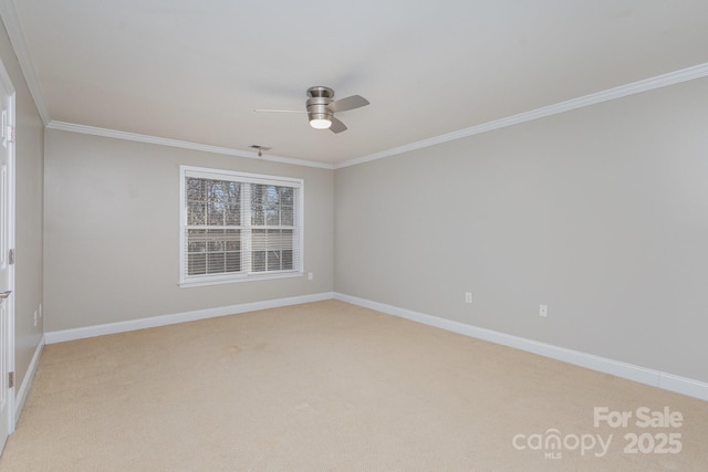 spare room featuring crown molding, light carpet, and ceiling fan