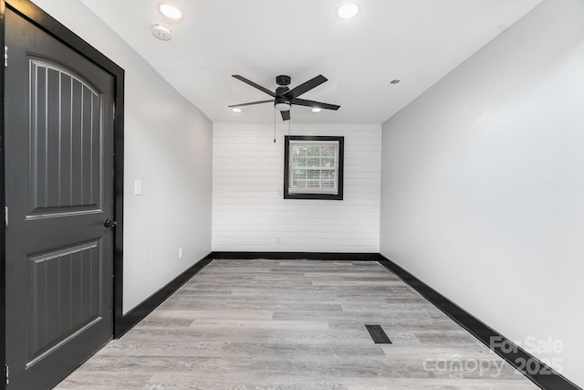 unfurnished room featuring ceiling fan and light hardwood / wood-style floors