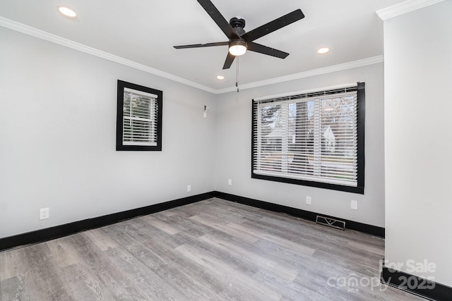 spare room with crown molding, ceiling fan, and light hardwood / wood-style floors