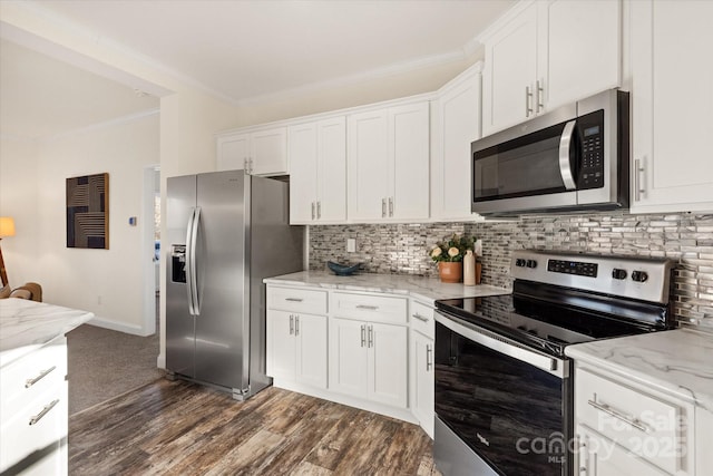 kitchen with tasteful backsplash, white cabinetry, stainless steel appliances, and crown molding