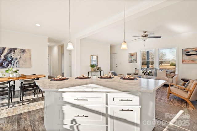 kitchen with ceiling fan, decorative light fixtures, open floor plan, white cabinetry, and dark wood-style flooring