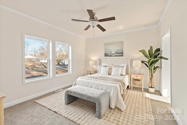 bedroom with crown molding, visible vents, baseboards, and carpet floors