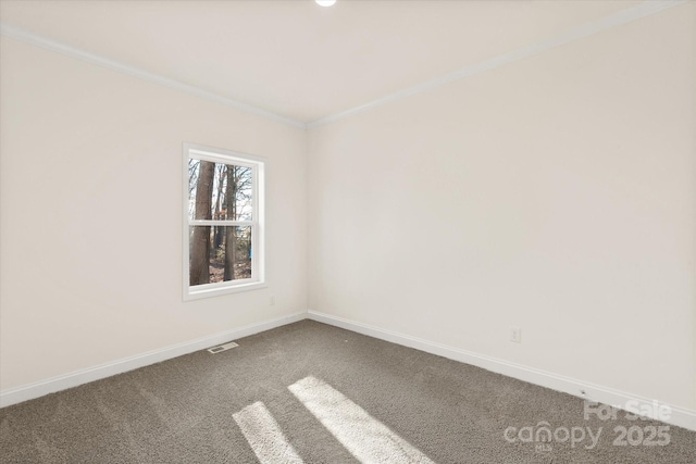 carpeted spare room with visible vents, baseboards, and ornamental molding