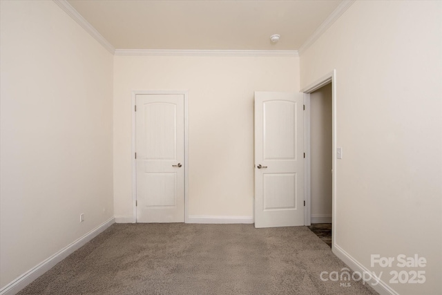 unfurnished bedroom with baseboards, ornamental molding, and carpet flooring