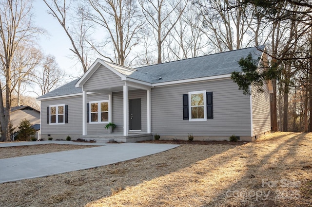 single story home with crawl space, a porch, and roof with shingles