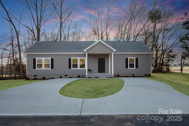 ranch-style house featuring roof with shingles, a lawn, driveway, and crawl space