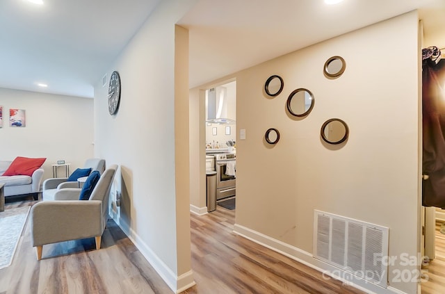 hallway with light hardwood / wood-style flooring