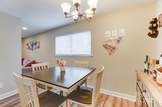 dining area with a notable chandelier and light wood-type flooring