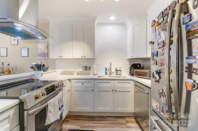 kitchen with sink, white cabinetry, stainless steel appliances, tasteful backsplash, and island exhaust hood