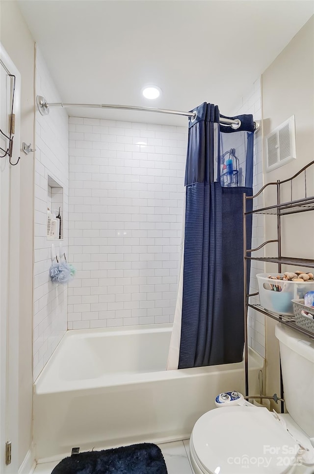 bathroom featuring toilet and shower / bath combo