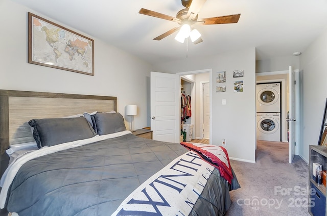 bedroom with ceiling fan, stacked washer and clothes dryer, and light carpet