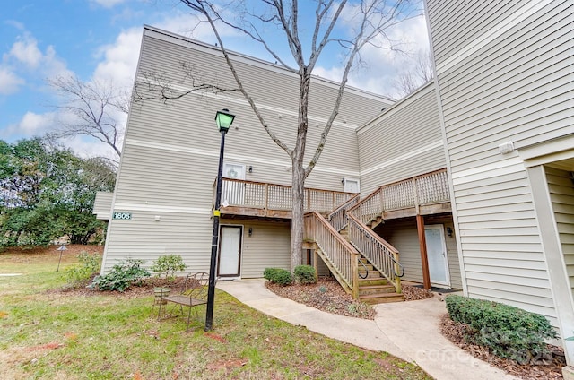 rear view of property with a lawn