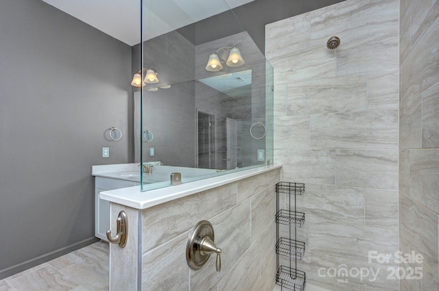 bathroom featuring vanity and a tile shower