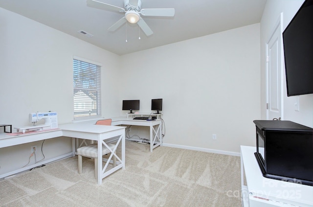 carpeted office space with ceiling fan