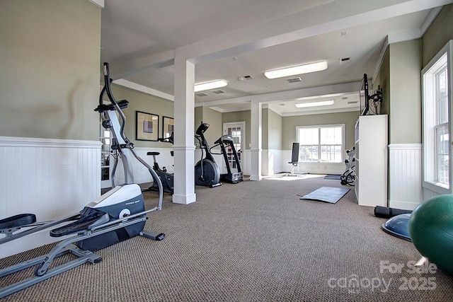 gym with ornate columns and carpet floors