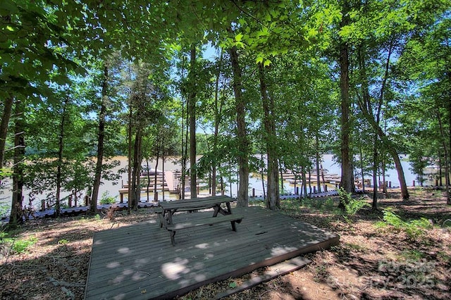 view of home's community with a deck with water view