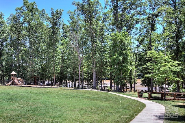 view of home's community with a yard and a playground