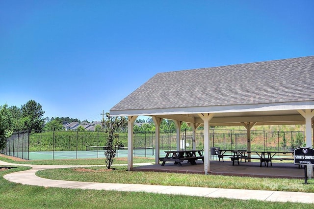 view of community with a gazebo, a yard, and tennis court