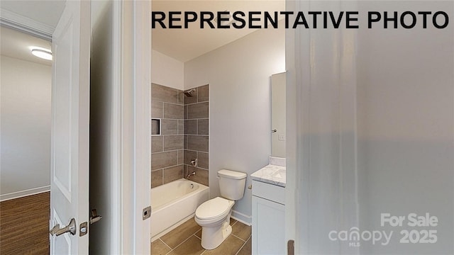 full bathroom with vanity, tiled shower / bath combo, toilet, and hardwood / wood-style flooring