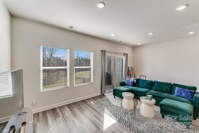 living room with light hardwood / wood-style flooring