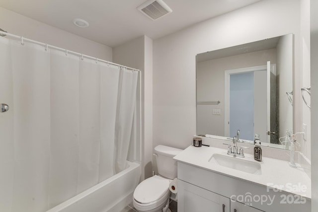 full bathroom featuring vanity, shower / bath combo, and toilet