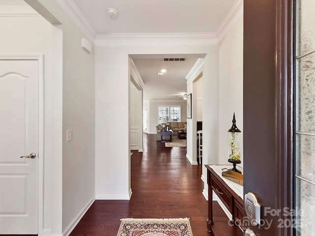 hall featuring dark wood-type flooring and ornamental molding