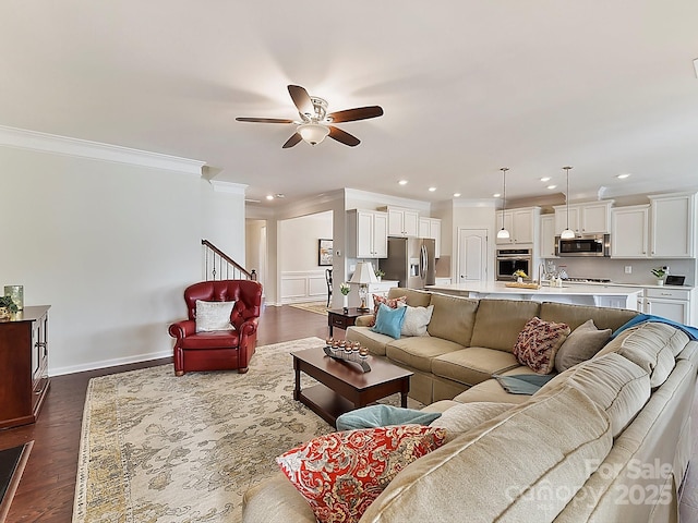 living room featuring dark wood-type flooring, ceiling fan, and ornamental molding