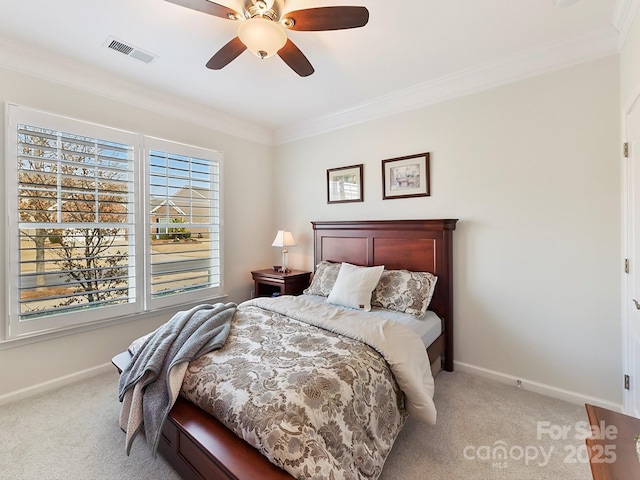 bedroom featuring light carpet, ornamental molding, and ceiling fan