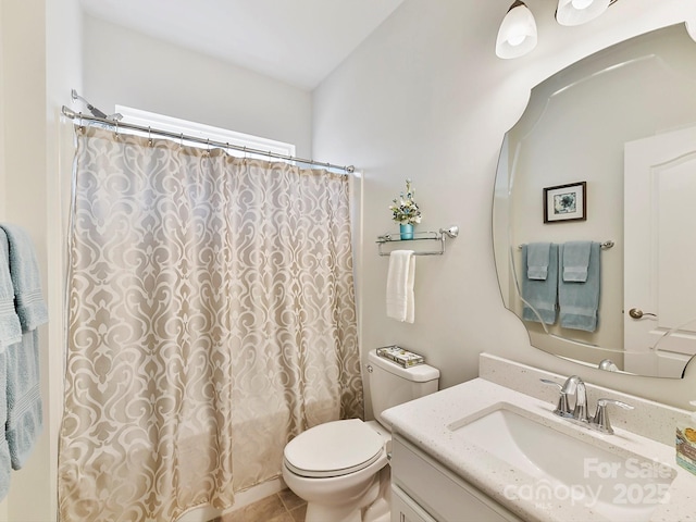 bathroom with a shower with curtain, vanity, tile patterned floors, and toilet