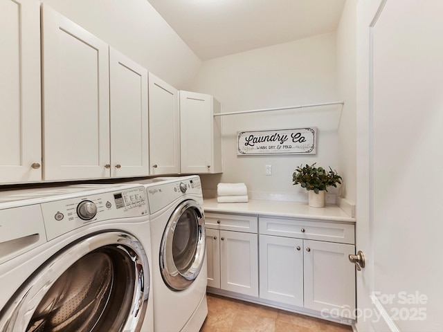 washroom with washer and clothes dryer and cabinets