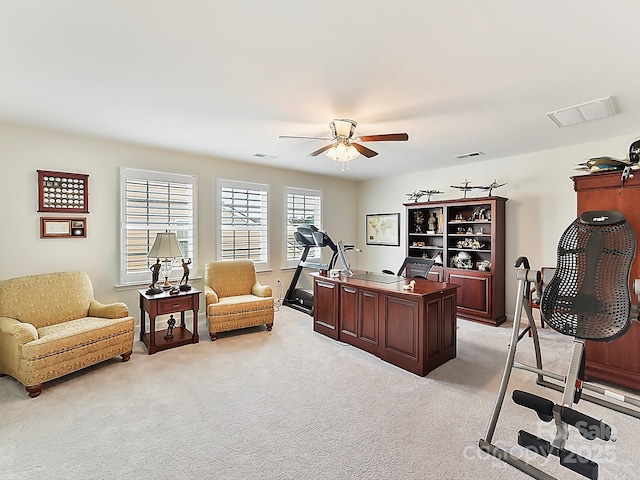 home office featuring light carpet and ceiling fan