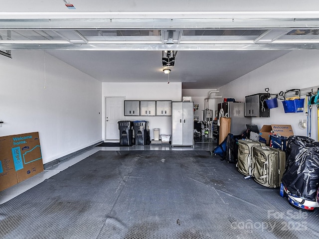 garage with stainless steel refrigerator and a garage door opener